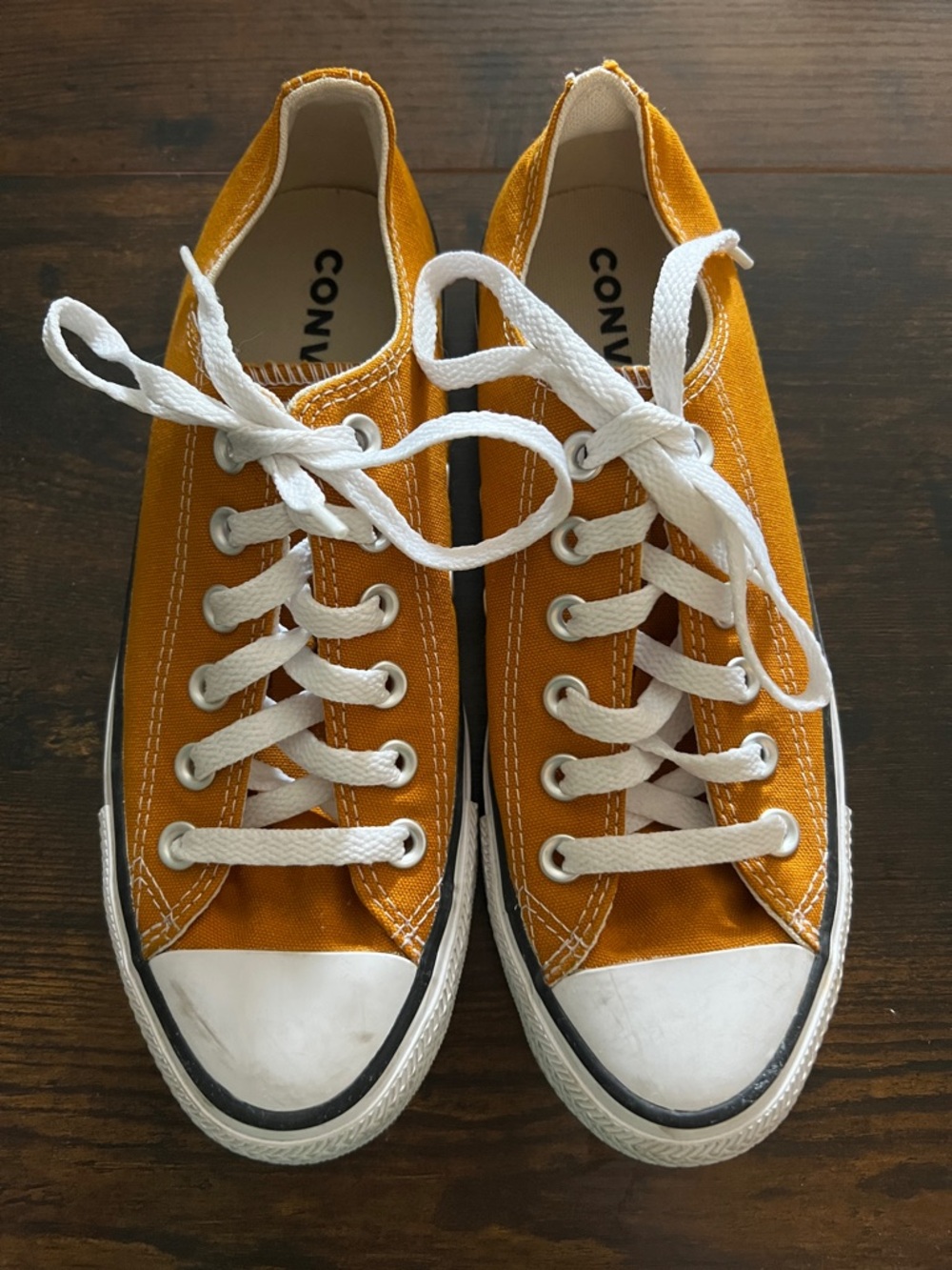 Converse low top sneakers in mustard yellow with white laces